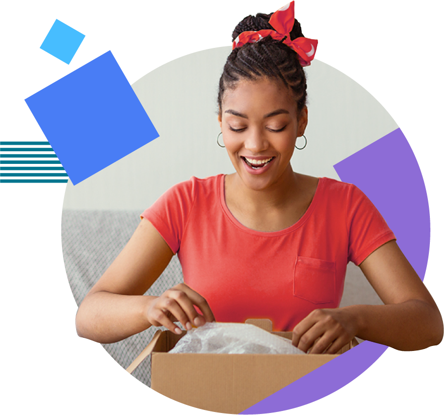 A smiling person happily opens a box.